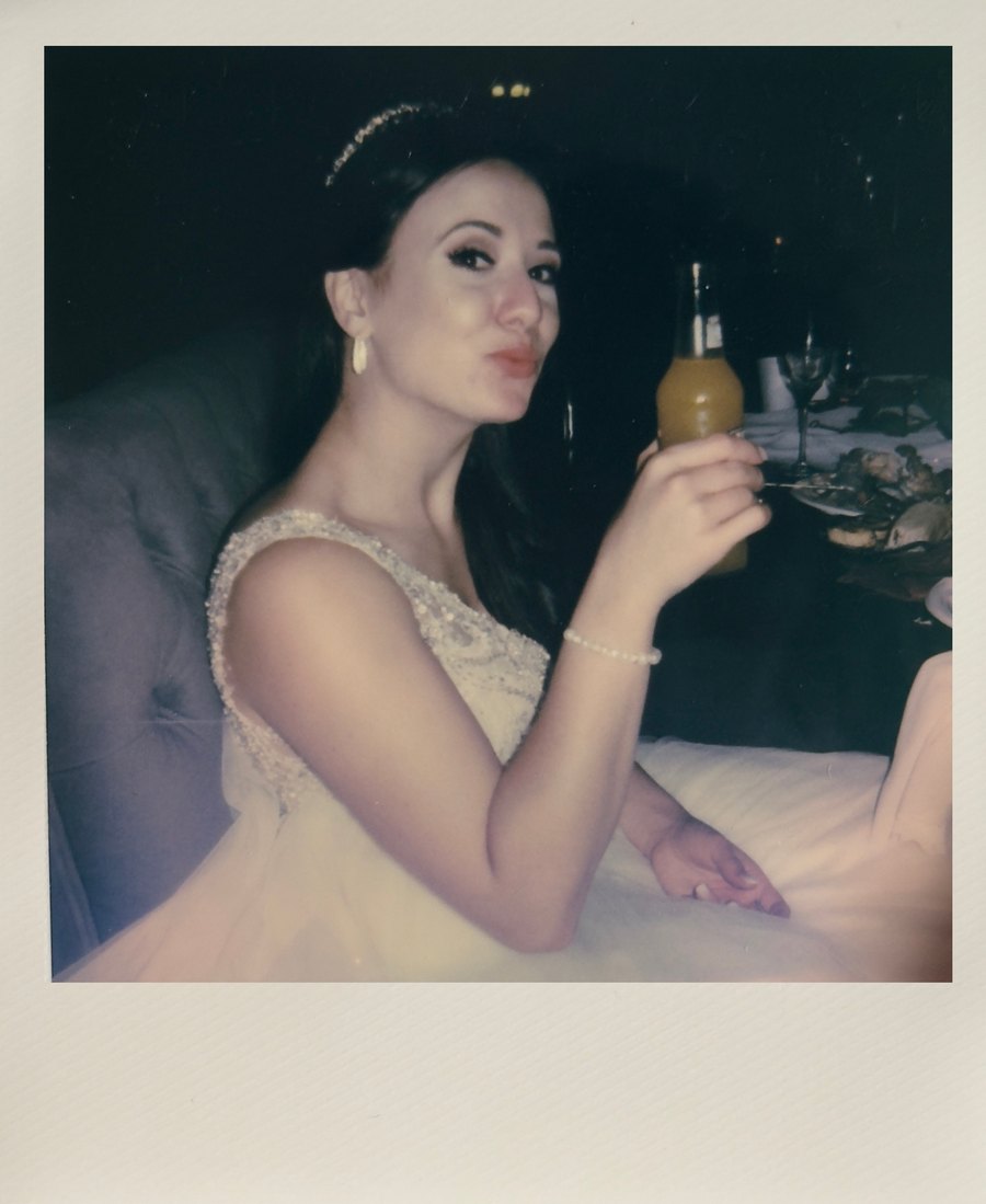 Instant wedding photo of the bride at her table